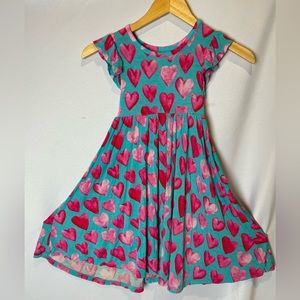 5T Posh Peanut twirl dress with ruffle sleeves. Heart pattern